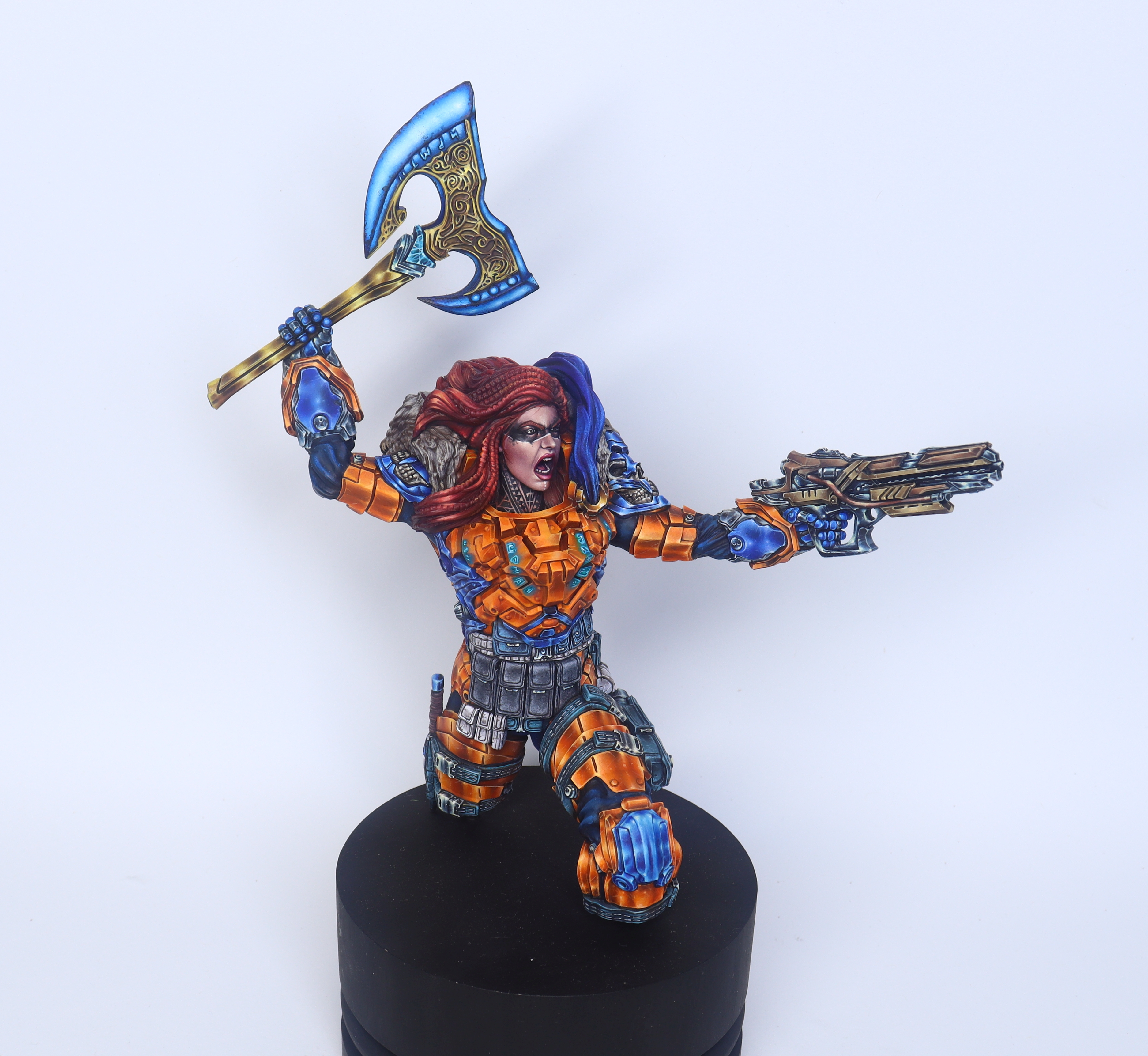 Post showcasing the excellently painted Sigrunn the Viking by @mb_shizune. Stunning in her orange armor, red hair, with her energy axe and reliable rifle. Pouches and magazines add great contrast to the overall look.