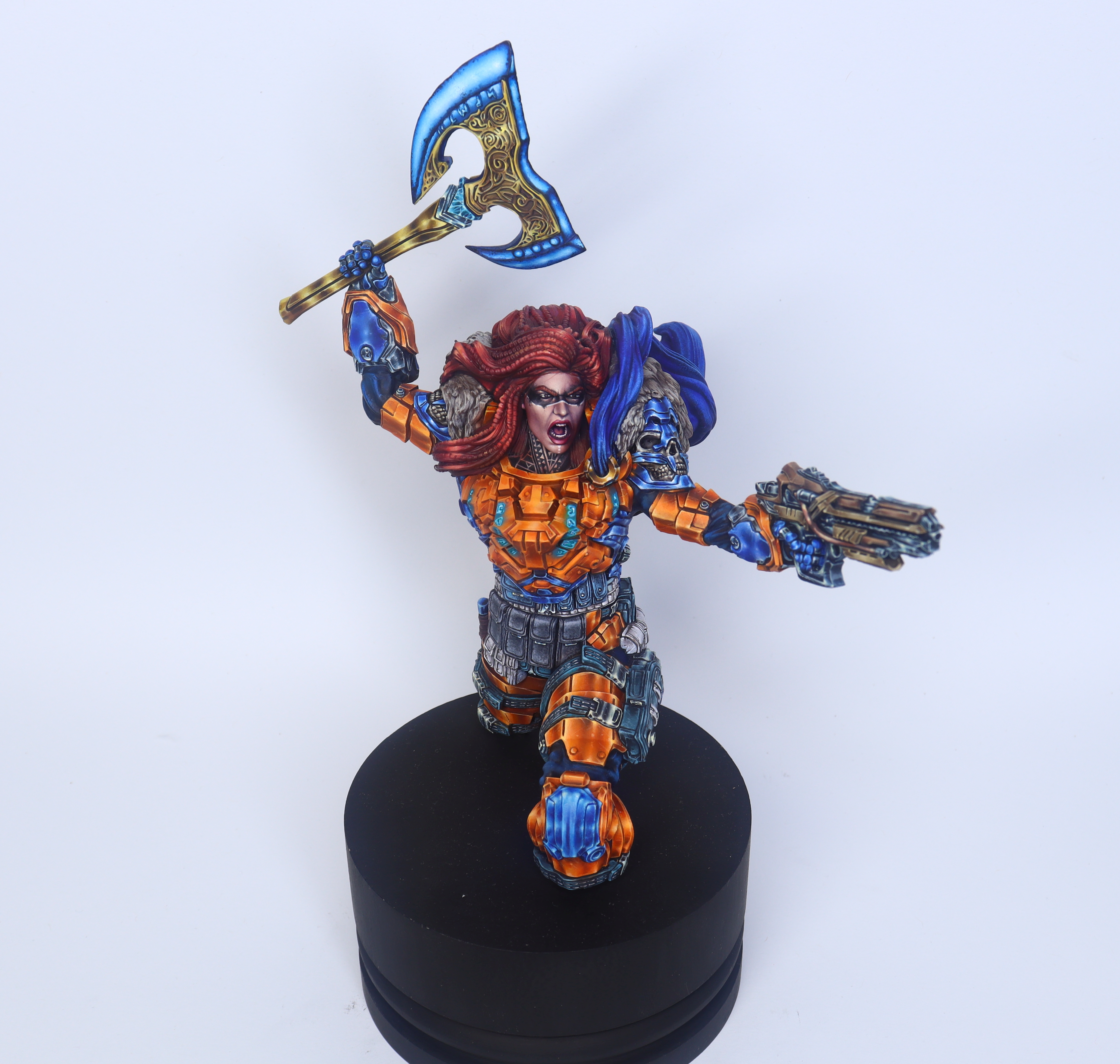 Post showcasing the excellently painted Sigrunn the Viking by @mb_shizune. Stunning in her orange armor, red hair, with her energy axe and reliable rifle. Pouches and magazines add great contrast to the overall look.